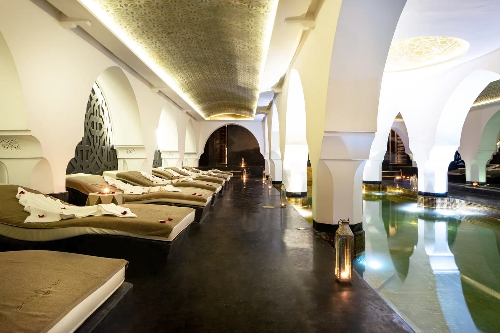 Riad Elisa spa pool beneath white arches