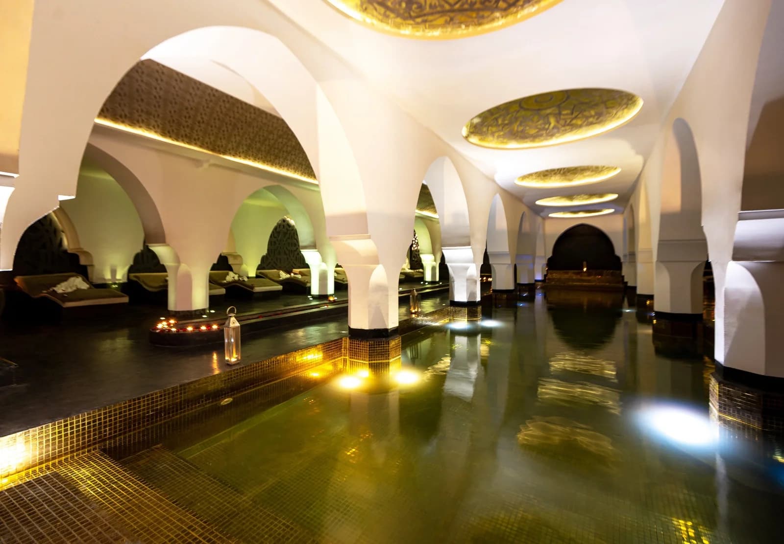 Riad Elisa spa pool beneath white arches
